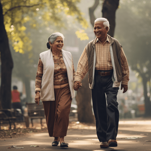 An elderly couple walk hand-in-hand happily on a street with tress in the back